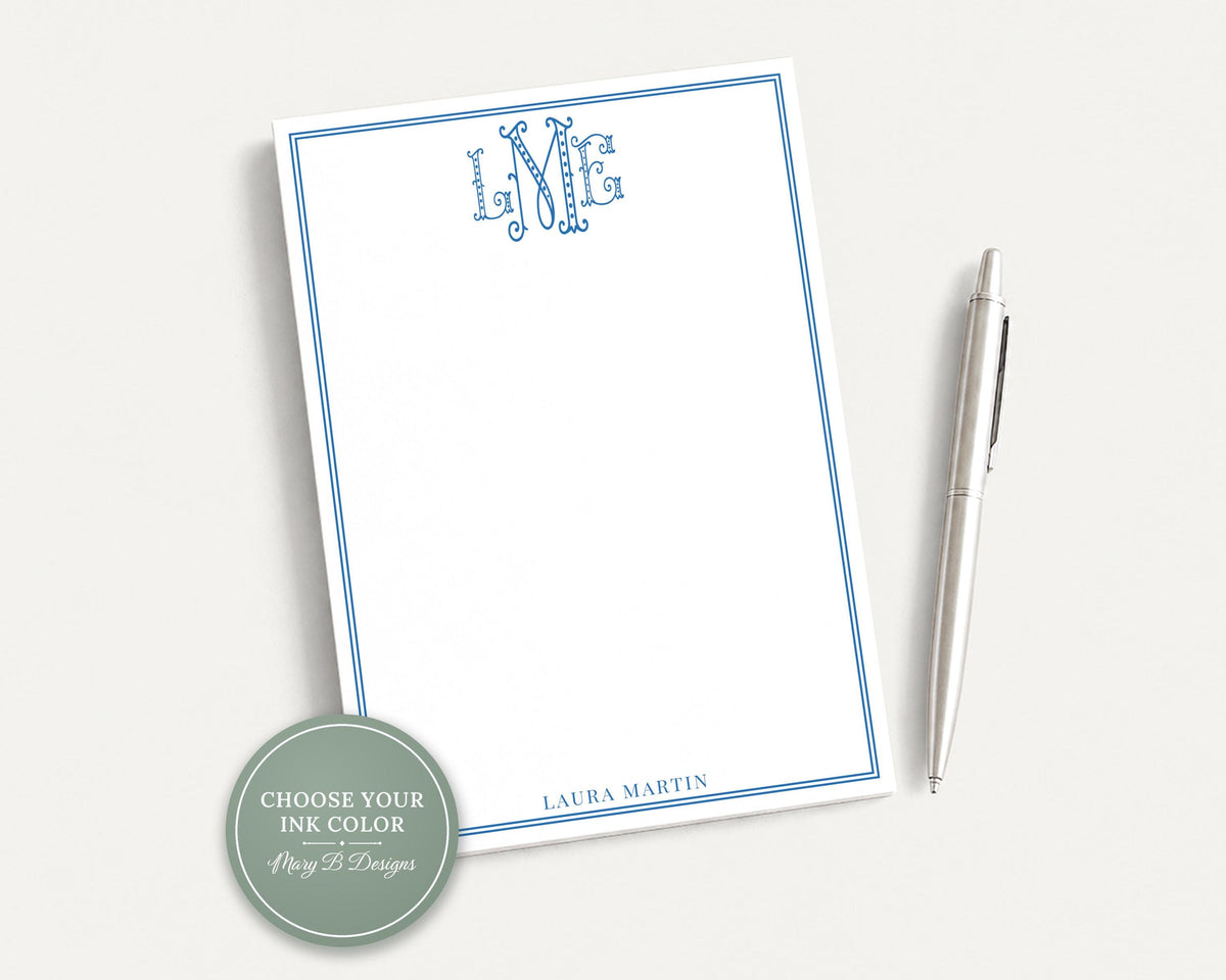 a blank white notepad with a blue border, accompanied by a silver pen on a white surface. __etsy:8254405981